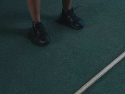 Close up of sports equipment on a dark wooden floor.